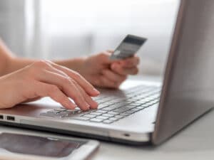 Woman holding credit card while online shopping