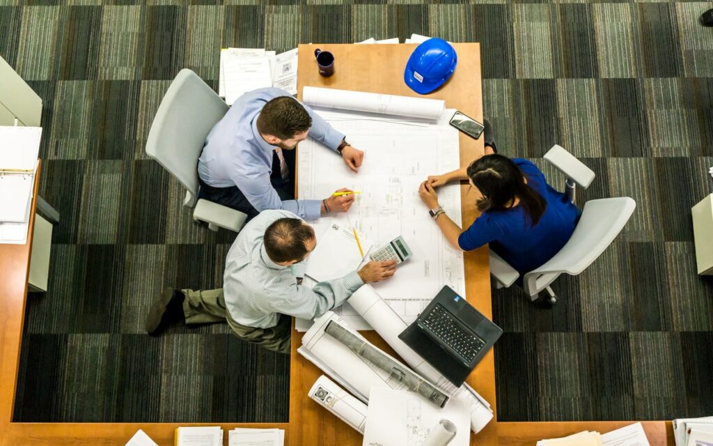 men and woman sitting at a table developing a response plan