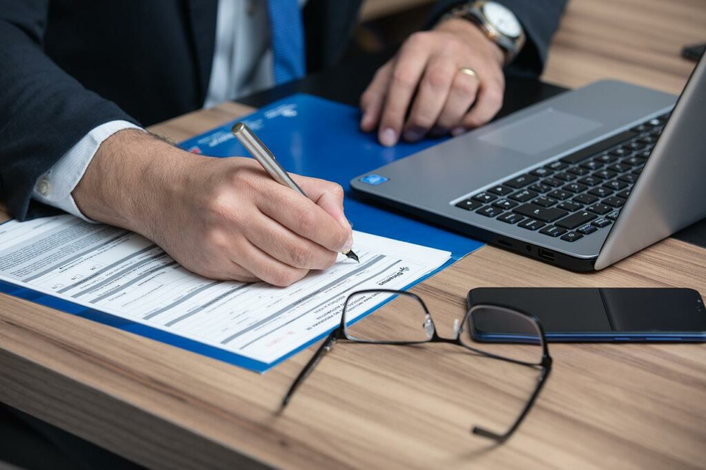 attorney working on a regulations contract at his desk in front of his computer