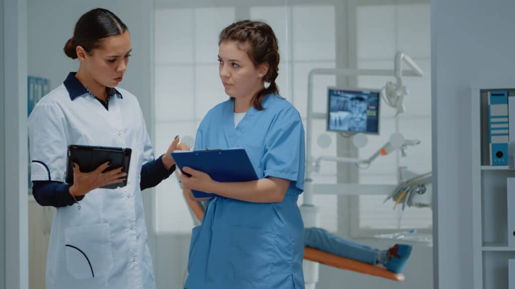 Female dental team utilizing technology to discuss plans