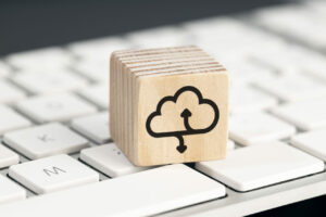 Cloud computing icon on wooden block on computer keyboard