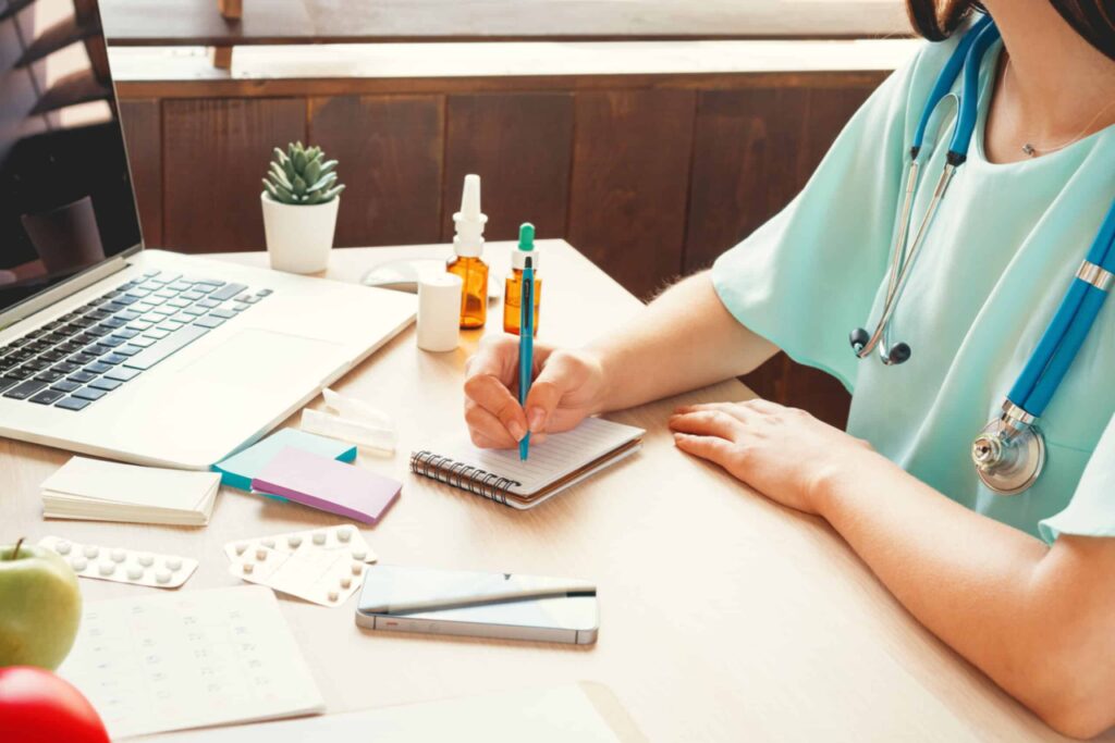 medical doctor taking notes in office