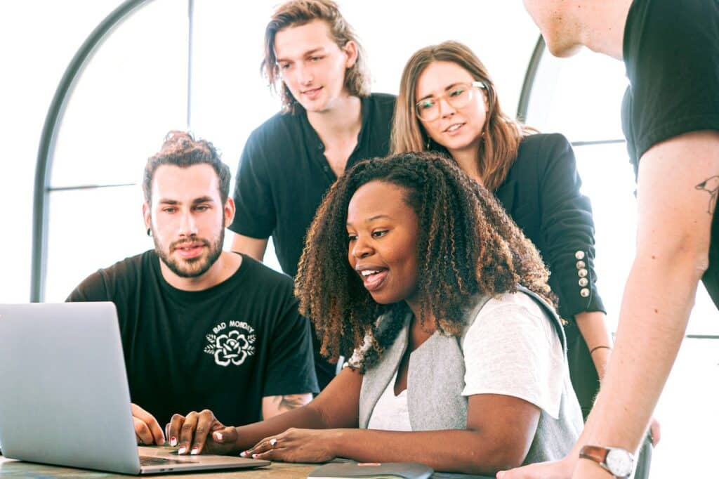 employees in a meeting, staring at computer screen